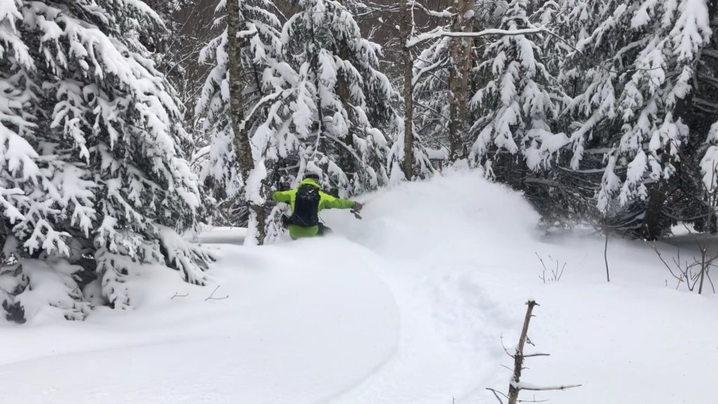 A Snowboarder Descends Into The Powder