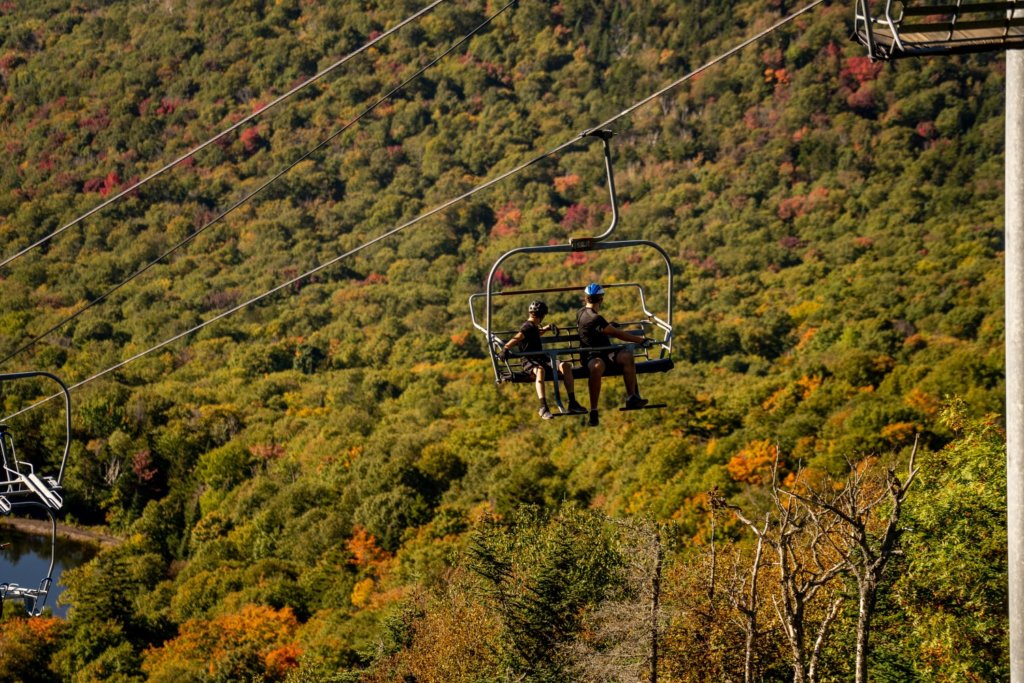 Two Lift Riders Turn in their Chair to Admire the View