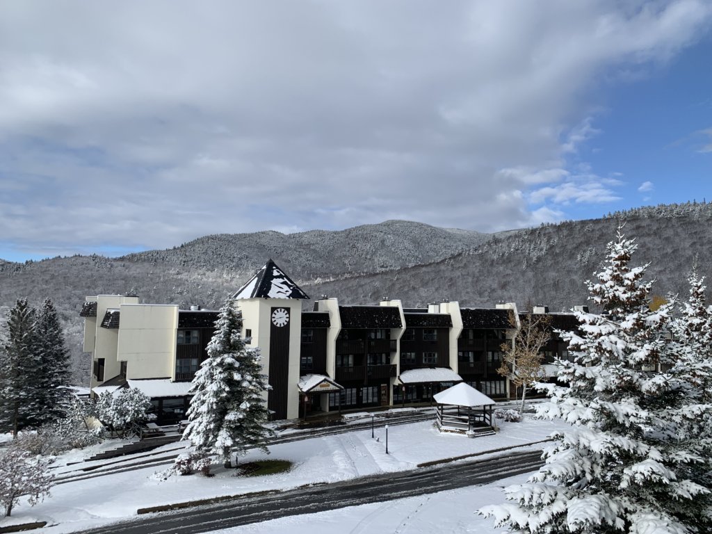 Snow covered Village Circle with mountain backdrop.